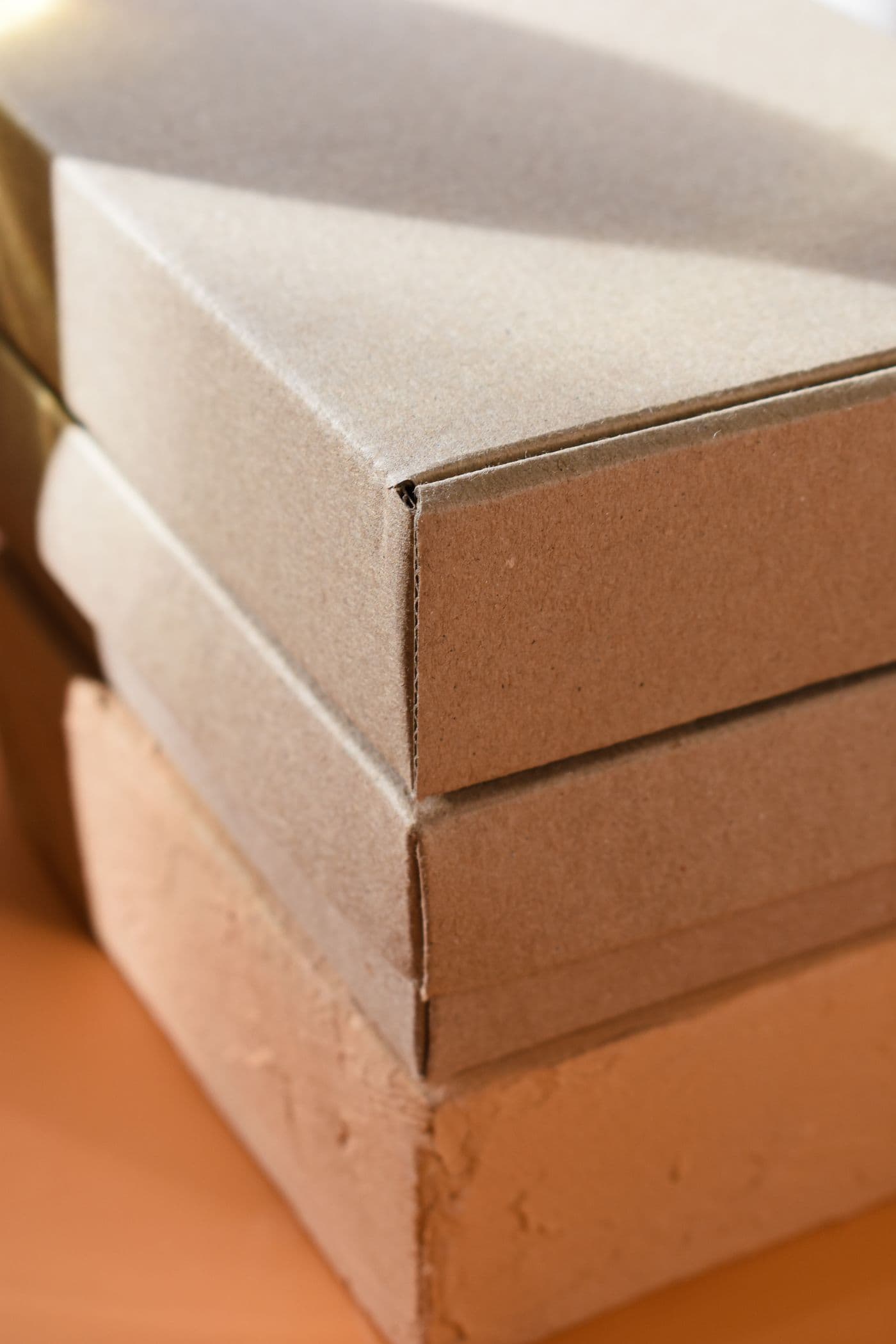 Printed folding cartons stacked flat before gluing