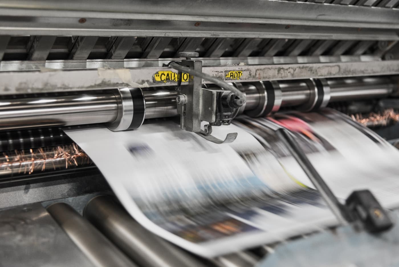 Printed sheets running through a press during a production run