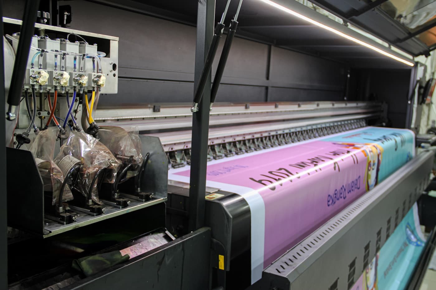 Large-format press printing a promotional banner